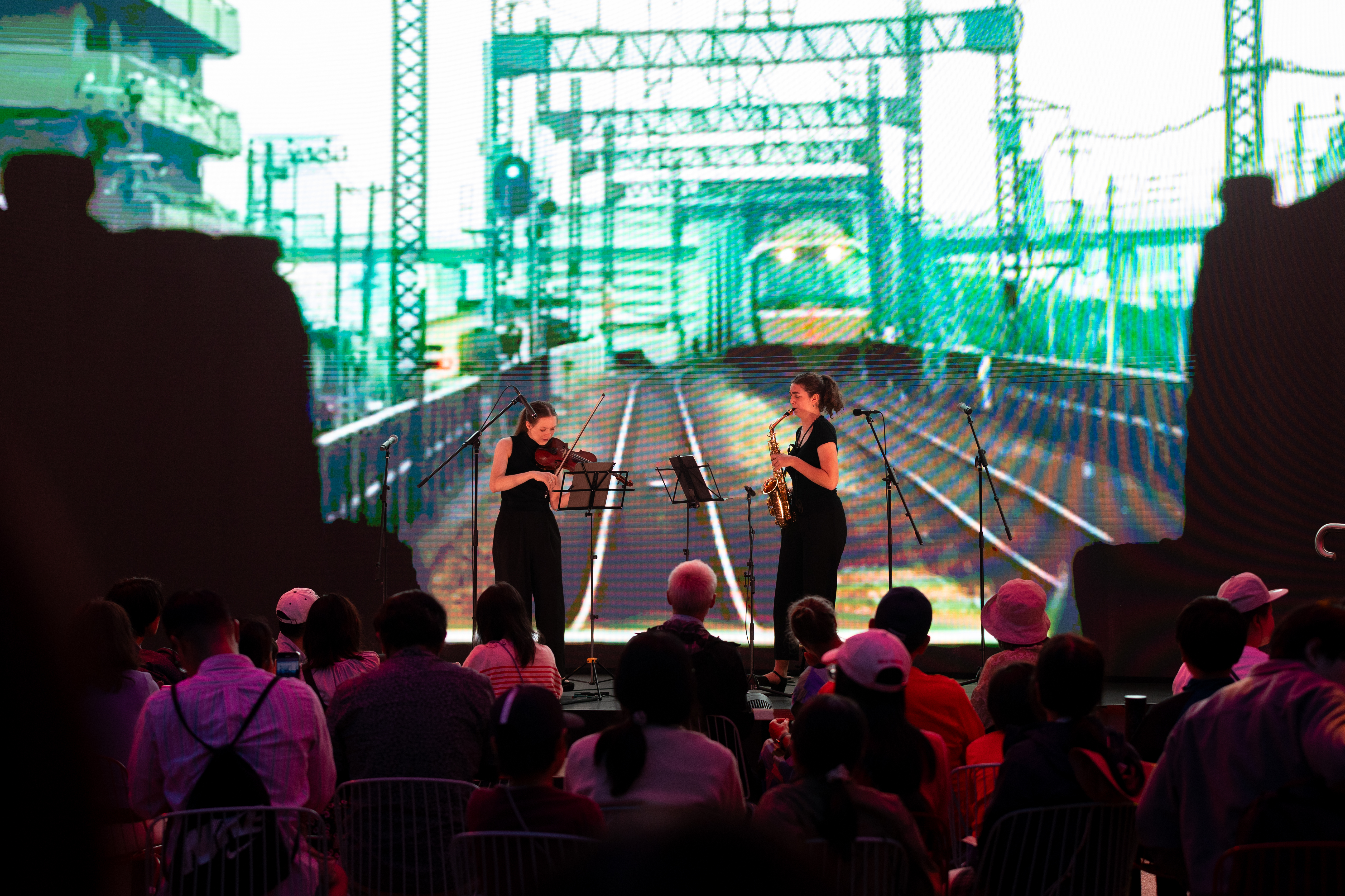 Duo Aki performing on stage at the Australia Pavilion