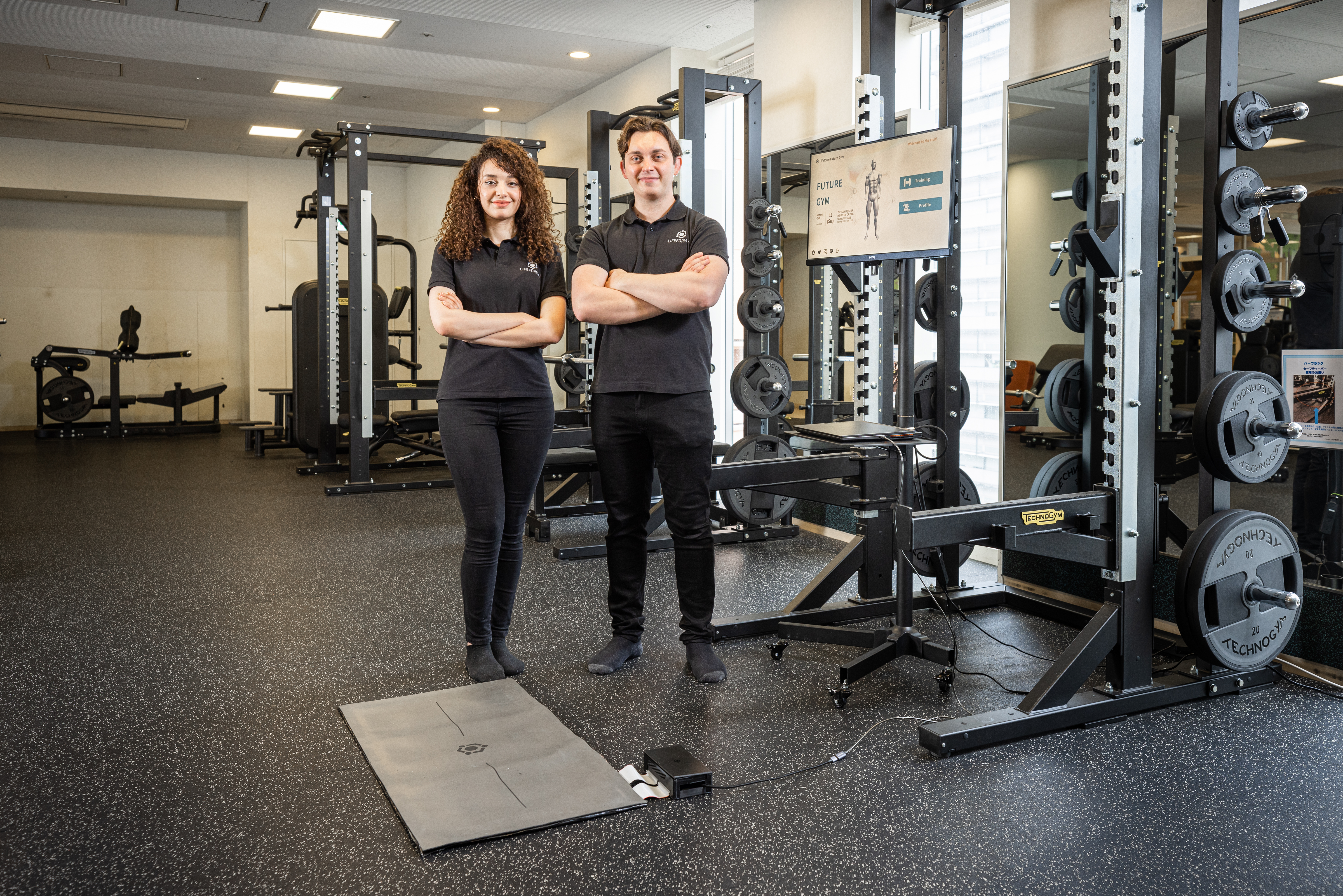 Lifeform AI team Karlos and Katia standing in a gym