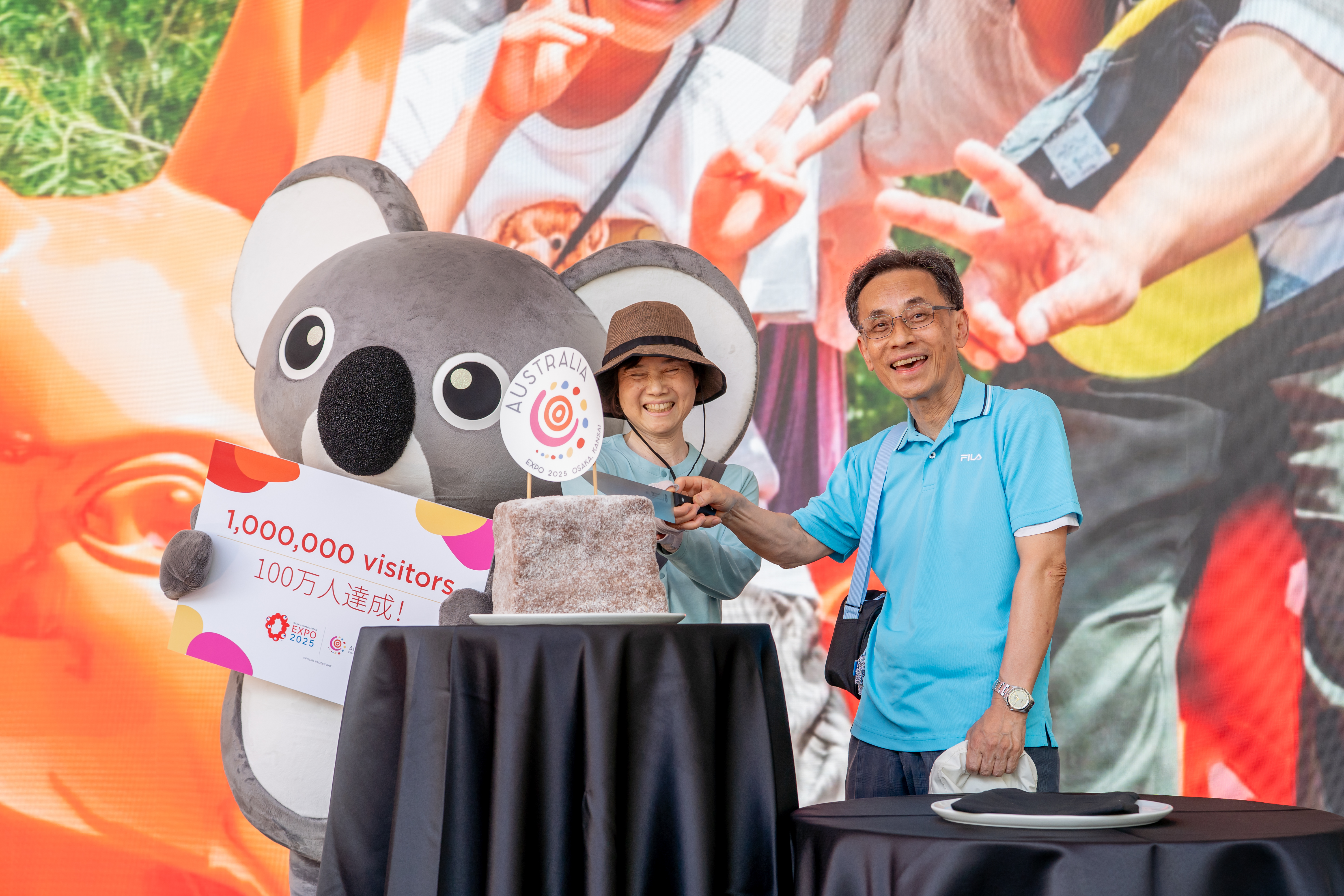 Koko the Koala alongside the one millionth visitor to the Australia Pavilion