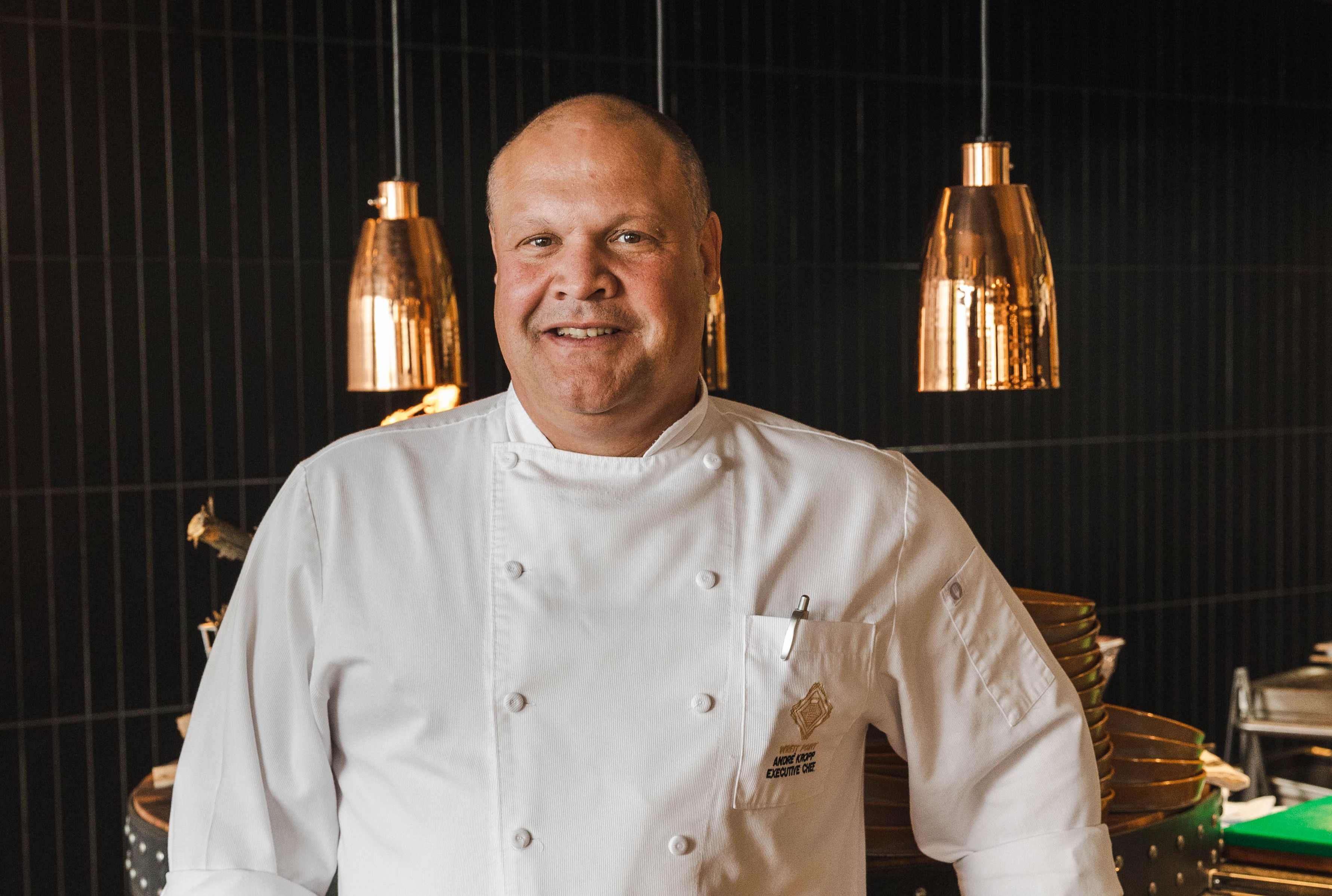 Chef Andre Kropp in a posed photograph in a kitchen